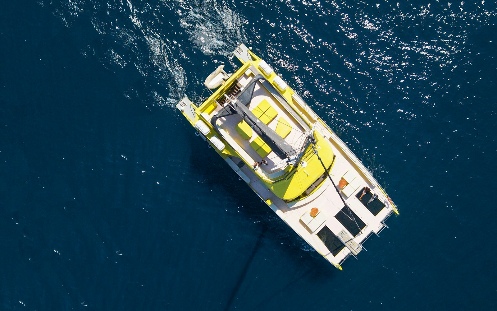 Catamaran sailing on blue waters during a Barcelona cruise.