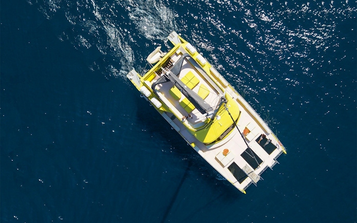 Catamaran sailing on blue waters during a Barcelona cruise.