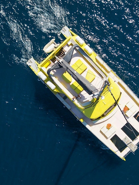 Catamaran sailing on blue waters during a Barcelona cruise.