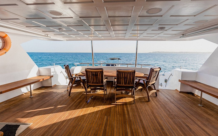 Deck of the Royal 1 motor yacht with seating, overlooking Orange Bay, Red Sea, Hurghada.