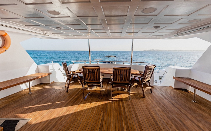 Deck of the Royal 1 motor yacht with seating, overlooking Orange Bay, Red Sea, Hurghada.
