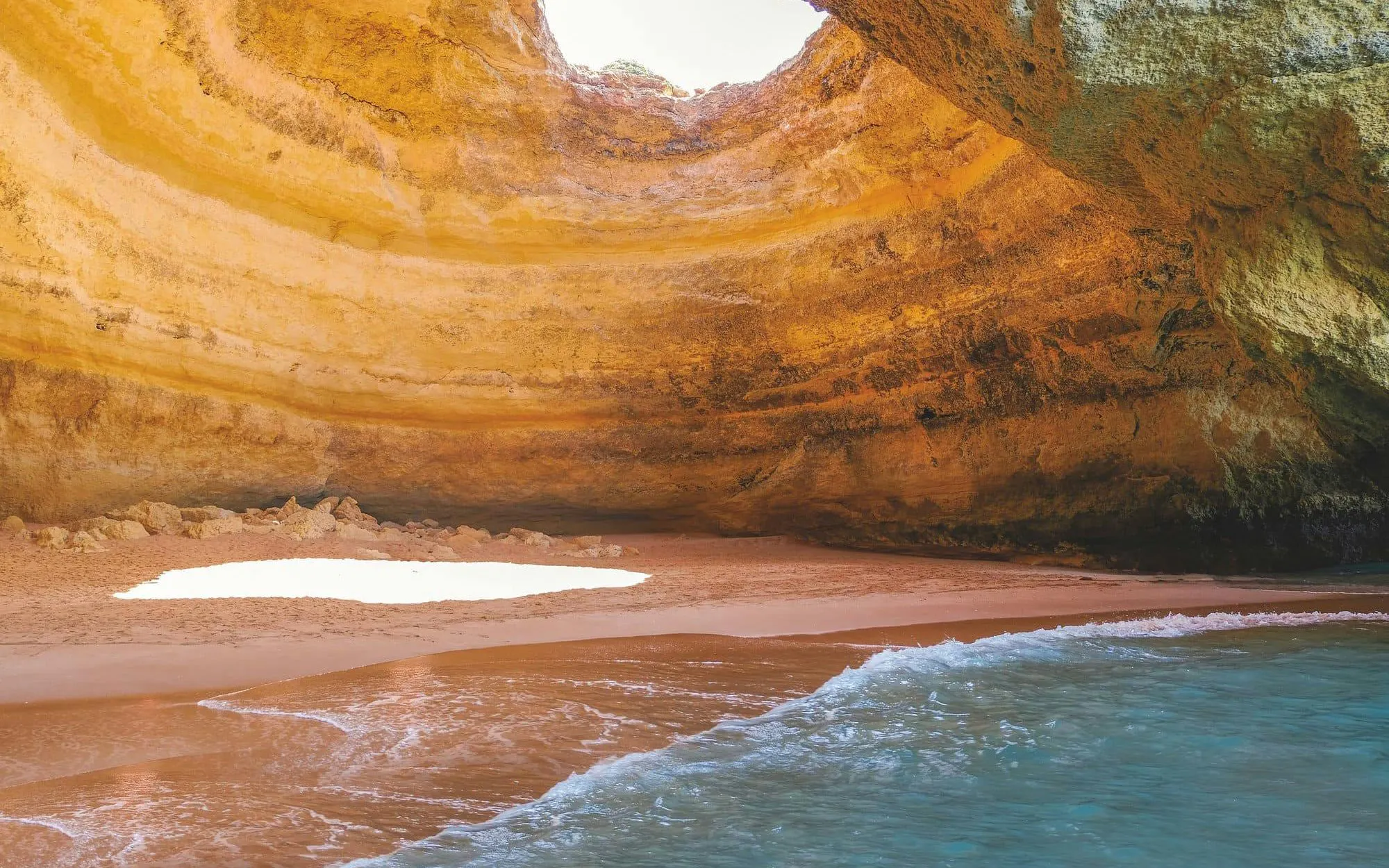 Benagil Caves in Algarve with sandy beach and ocean view.