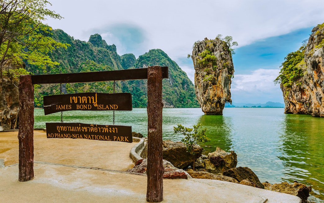 James Bond Island sign with limestone karst in Ao Phang Nga National Park, Thailand.