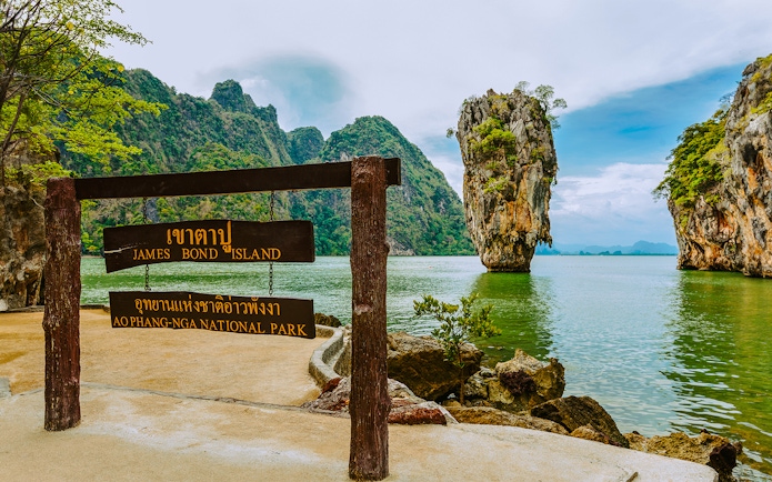 James Bond Island sign with limestone karst in Ao Phang Nga National Park, Thailand.