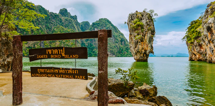 James Bond Island sign with limestone karst in Ao Phang Nga National Park, Thailand.