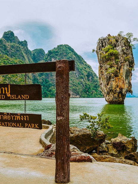James Bond Island sign with limestone karst in Ao Phang Nga National Park, Thailand.