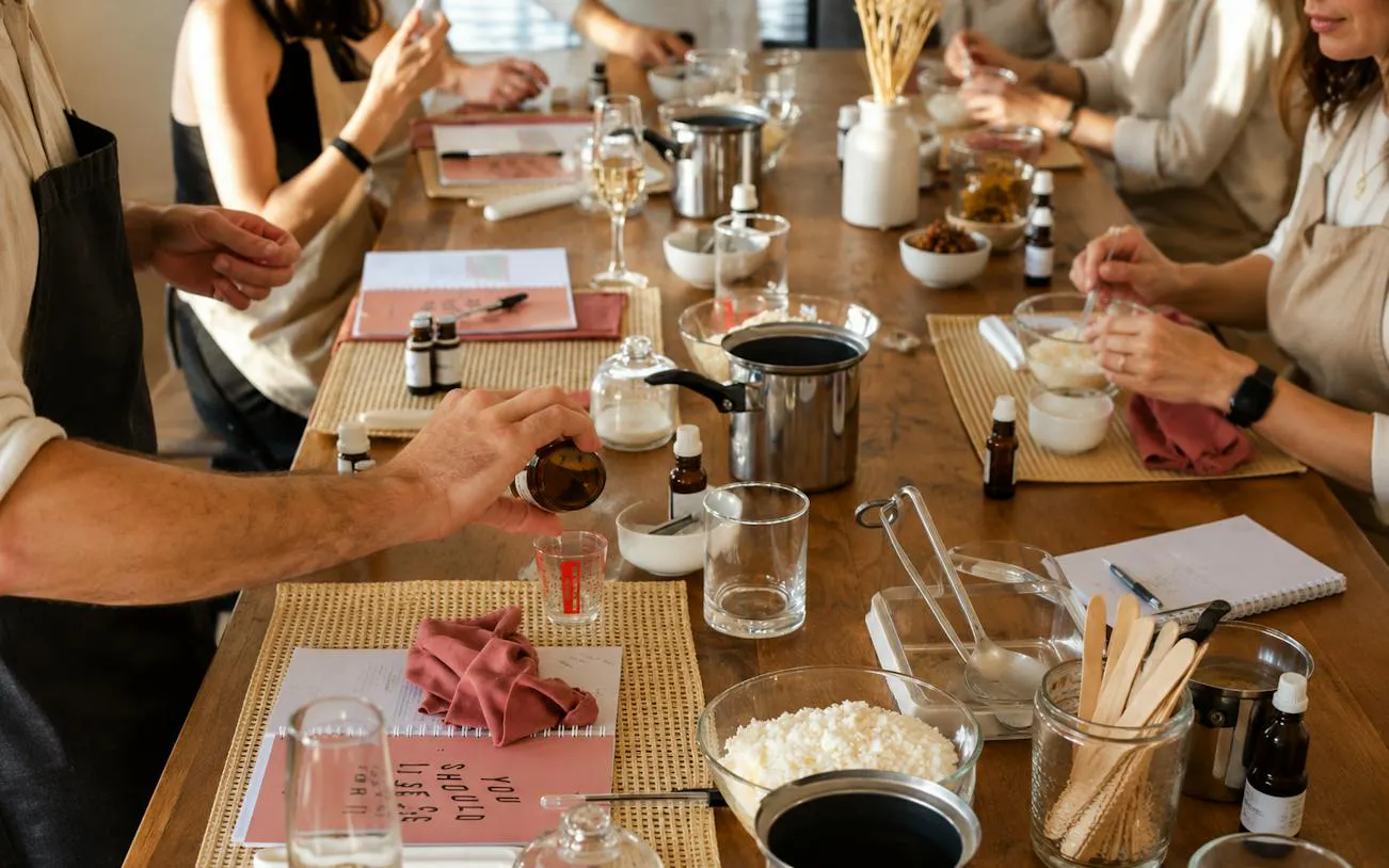 Candle-making workshop with participants mixing fragrances in a Krakow studio.