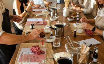 Candle-making workshop with participants mixing fragrances in a Krakow studio.