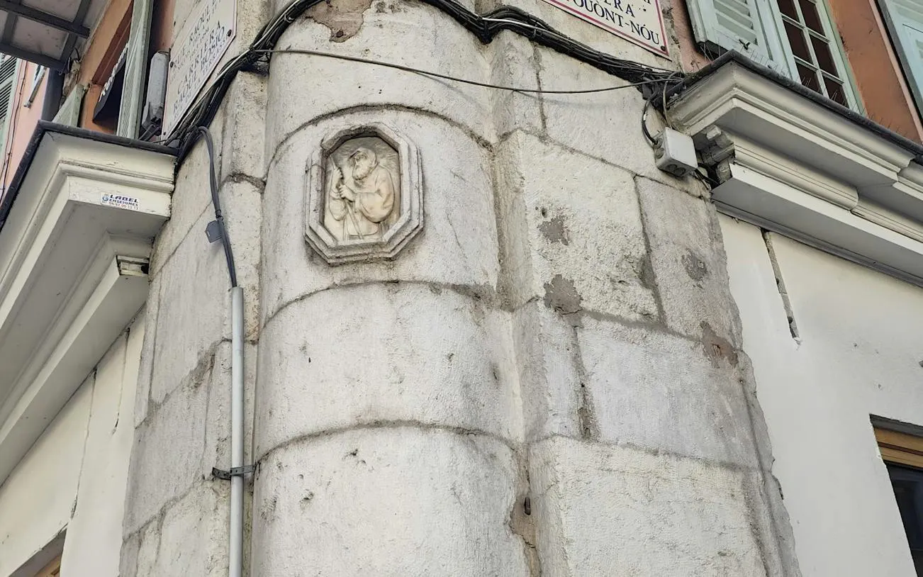Stone relief on a building corner in Nice, part of the Murder Mystery City Exploration Game.