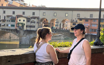 Visitors enjoying the view of Ponte Vecchio in Florence during a Renaissance day tour.