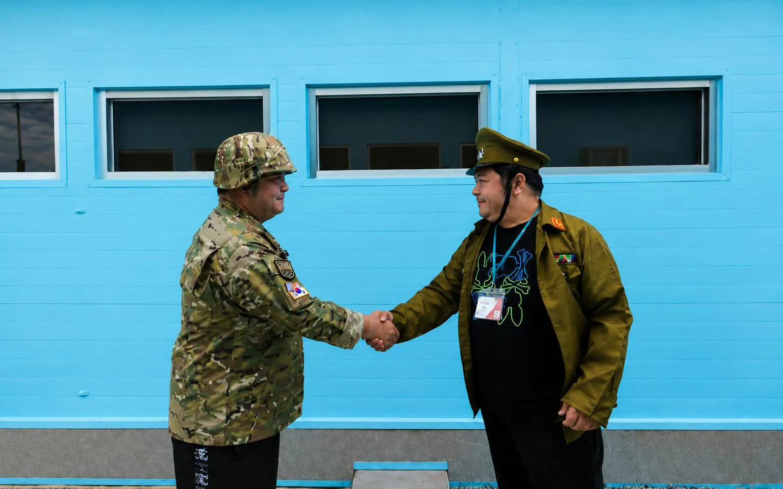 Soldiers shaking hands at the DMZ during the Half Day DMZ Tour with JSA Photo Zone.