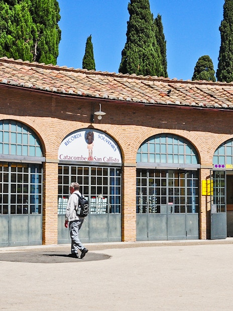 Tourist entering ticket office for Catacombs of St. Callixtus in Rome.