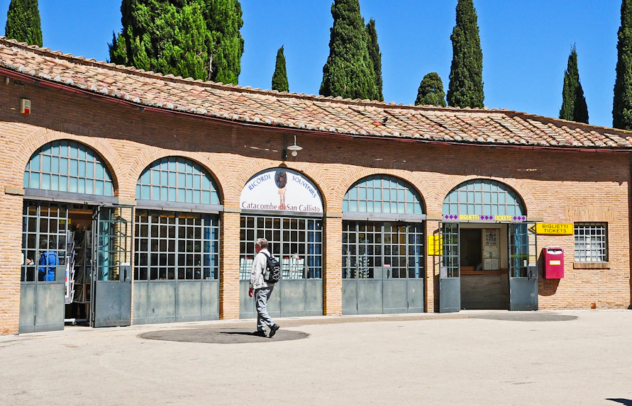 Tourist entering ticket office for Catacombs of St. Callixtus in Rome.