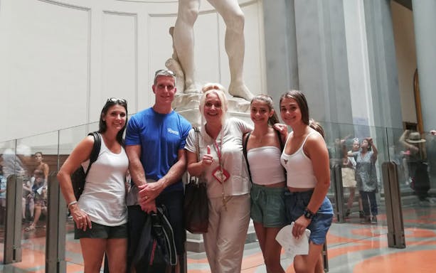 Visitors at Accademia Gallery with Michelangelo's David in Florence.