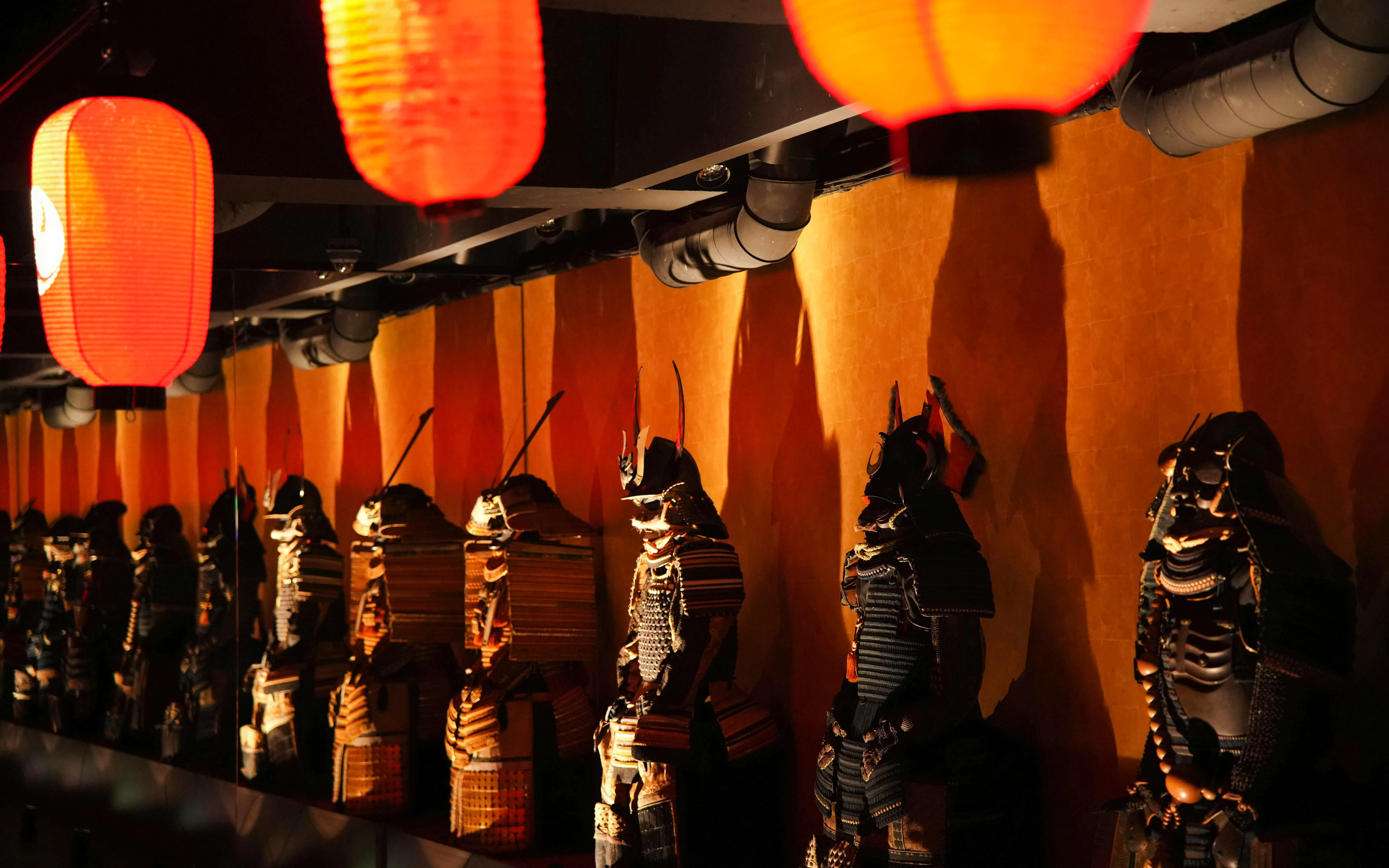 Samurai armor display under lanterns at Samurai & Ninja Museum, Tokyo.