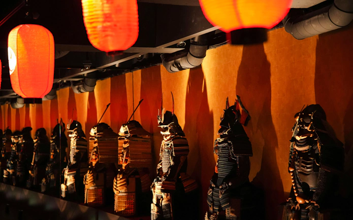 Samurai armor display under lanterns at Samurai & Ninja Museum, Tokyo.