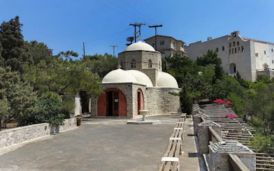 Prophet Elias Monastery with stone architecture and domes, Santorini.