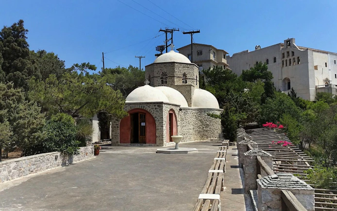 Prophet Elias Monastery with stone architecture and domes, Santorini.