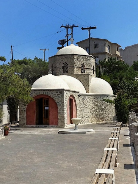 Prophet Elias Monastery with stone architecture and domes, Santorini.