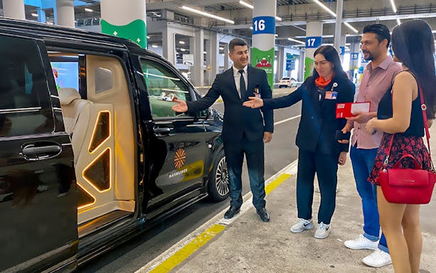 Private transfer service at Sabiha Gokcen Airport, Istanbul, with luxury vehicle and welcoming staff.
