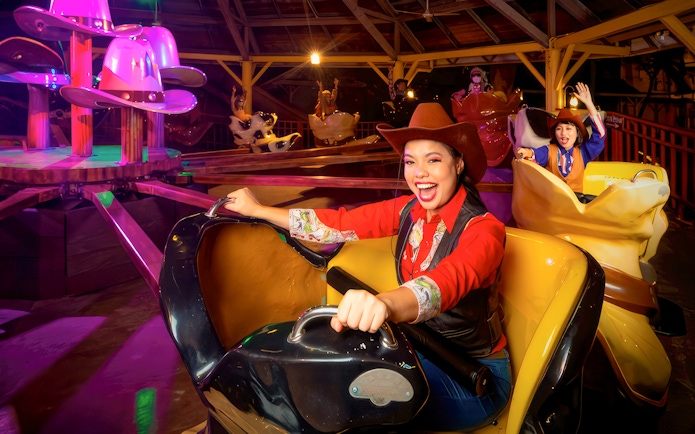 Visitors enjoying a cowboy-themed ride at Sunway Lagoon Night Park.