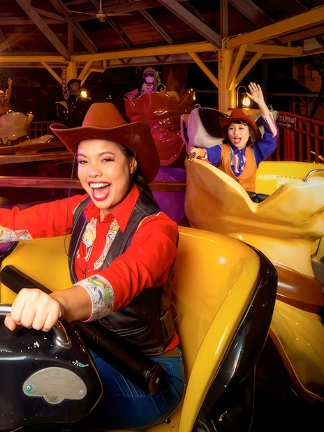 Visitors enjoying a cowboy-themed ride at Sunway Lagoon Night Park.