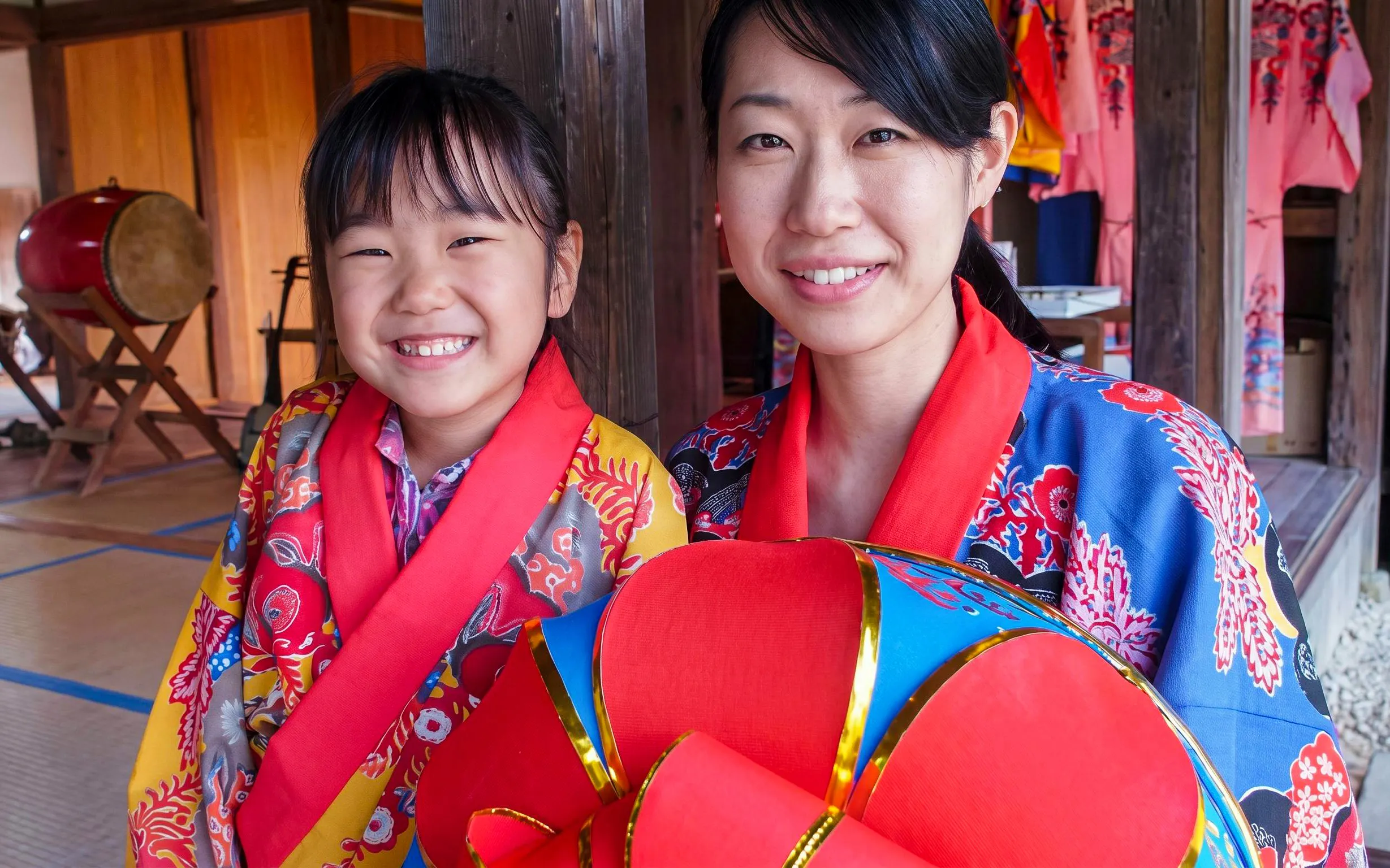 Visitors in traditional attire at Ishigaki Yaima Village, Okinawa.
