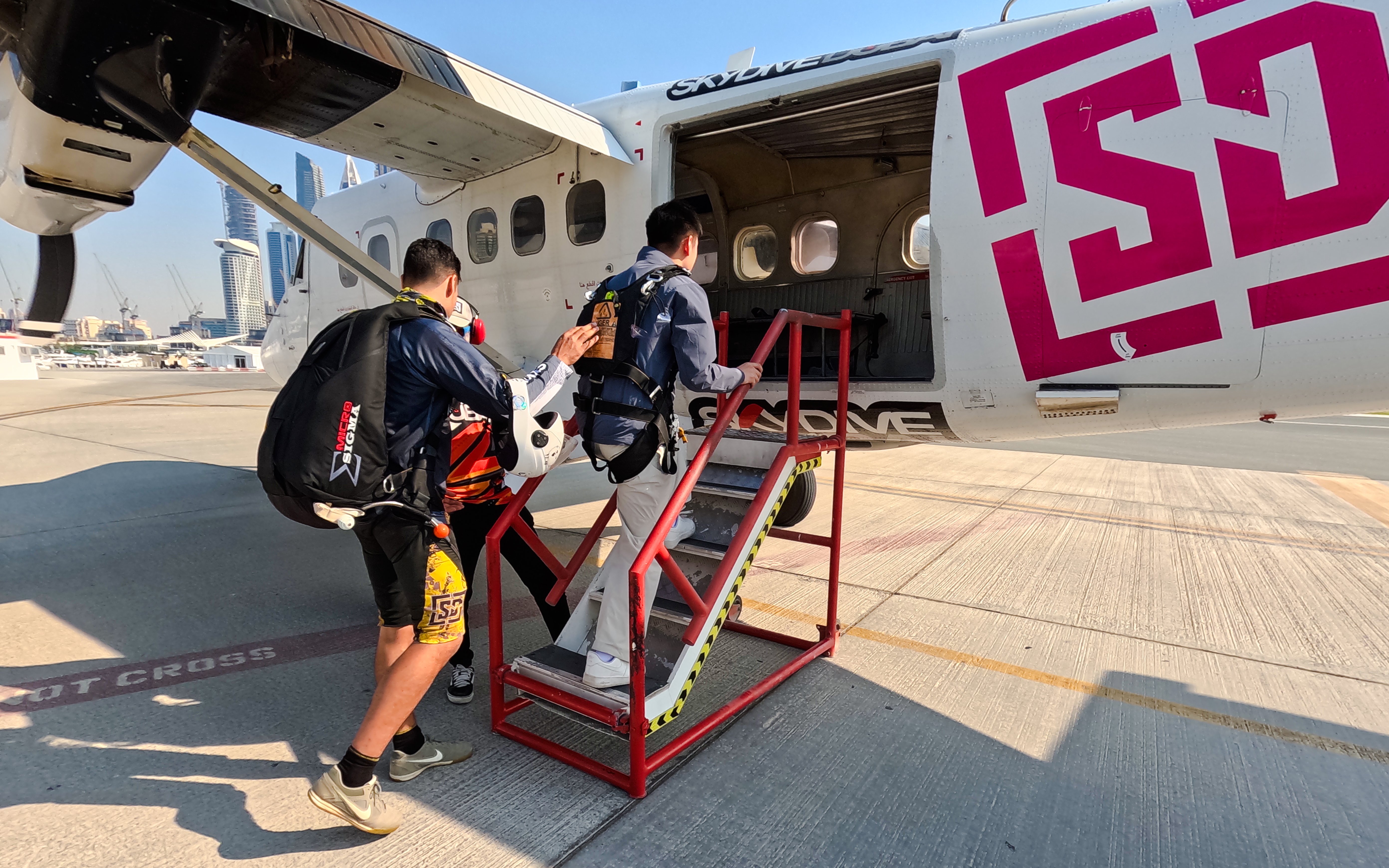 Skydiving guests boarding plane in Dubai for tandem jump experience.