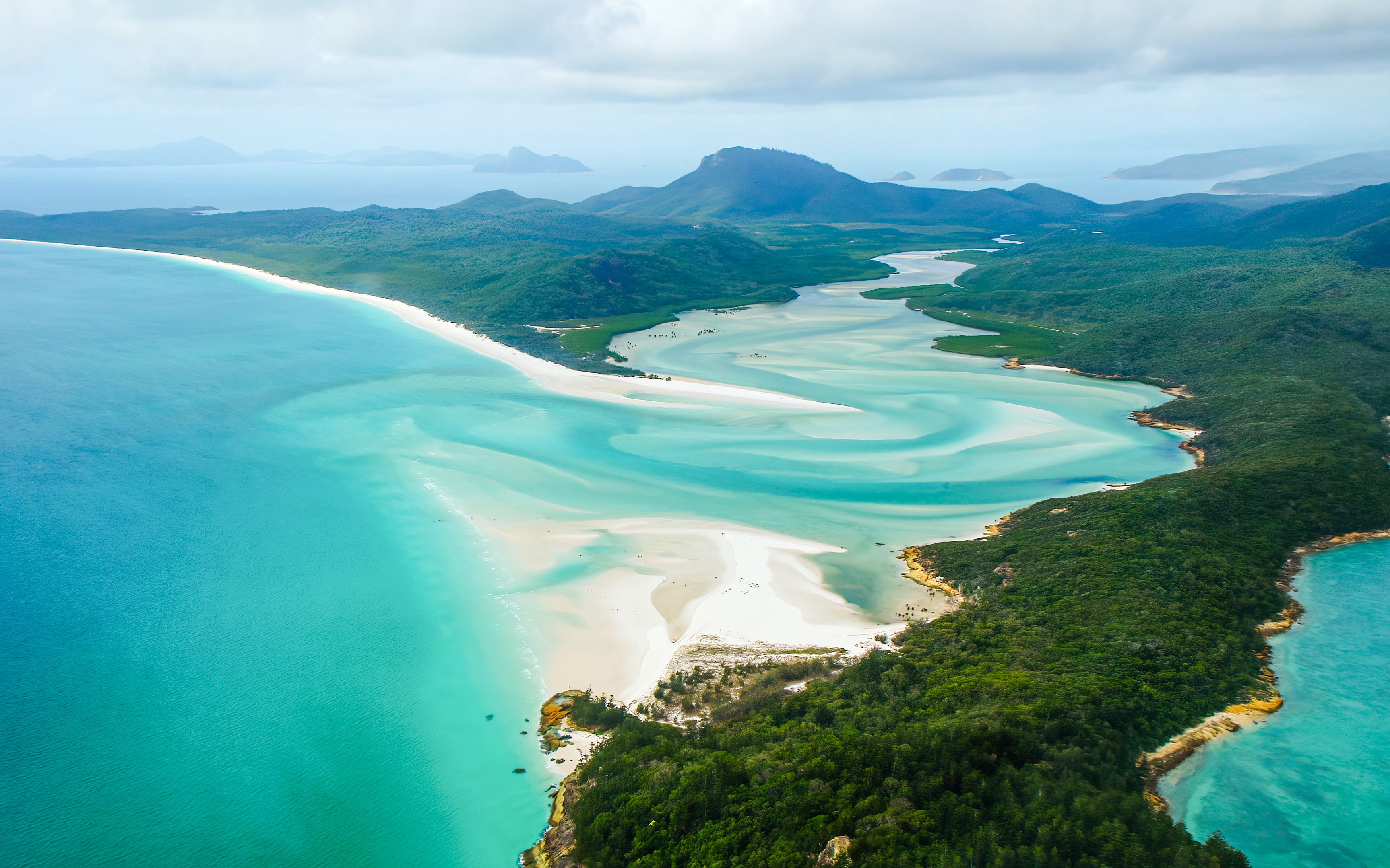 Aerial view of Hill Inlet sandbank on Whitsunday Island, Queensland, with turquoise waters and lush greenery.