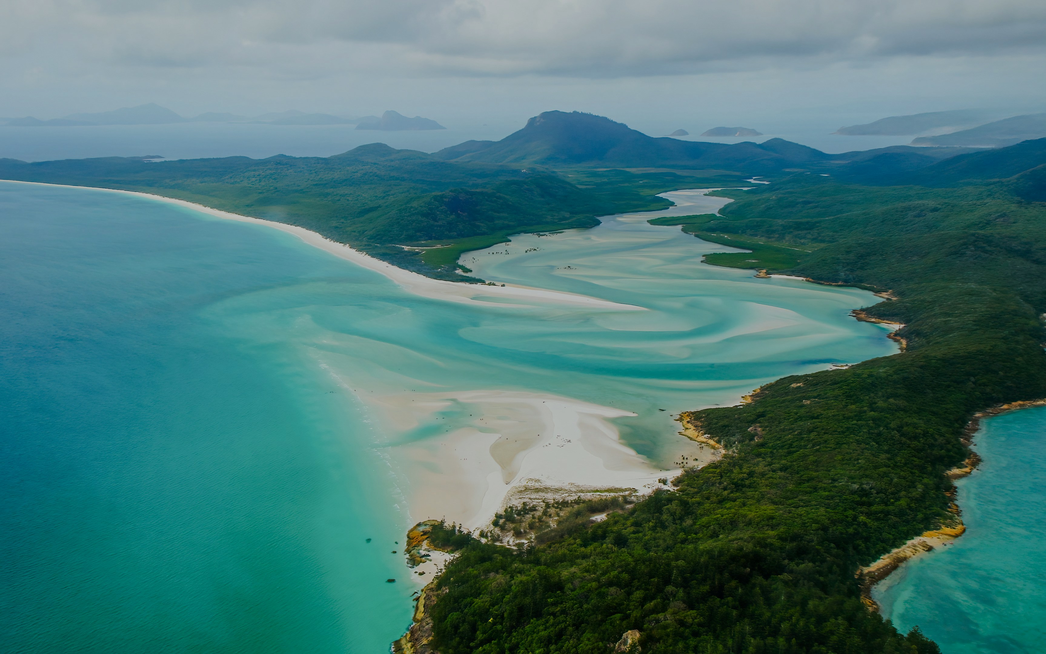 Aerial view of Hill Inlet sandbank on Whitsunday Island, Queensland, with turquoise waters and lush greenery.