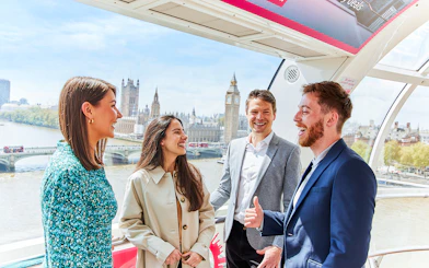 Group enjoying view of Big Ben and Houses of Parliament from London Eye capsule.