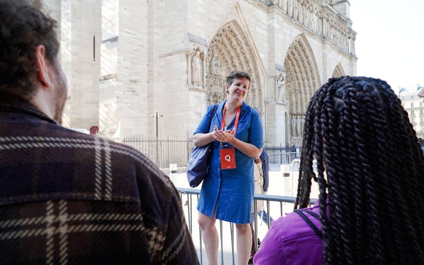 Guide speaking to tourists in front of Notre Dame Cathedral, Paris.