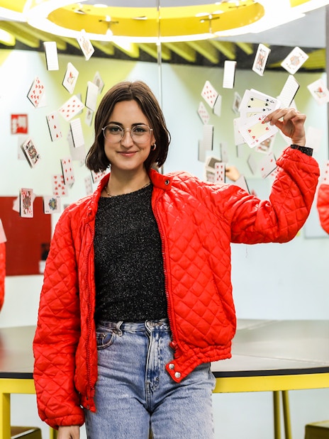 Person holding playing cards in front of mirrors at Museum of Illusions, Madrid.