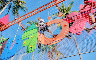 Children climbing colorful obstacle course at a birthday party in Phuket.
