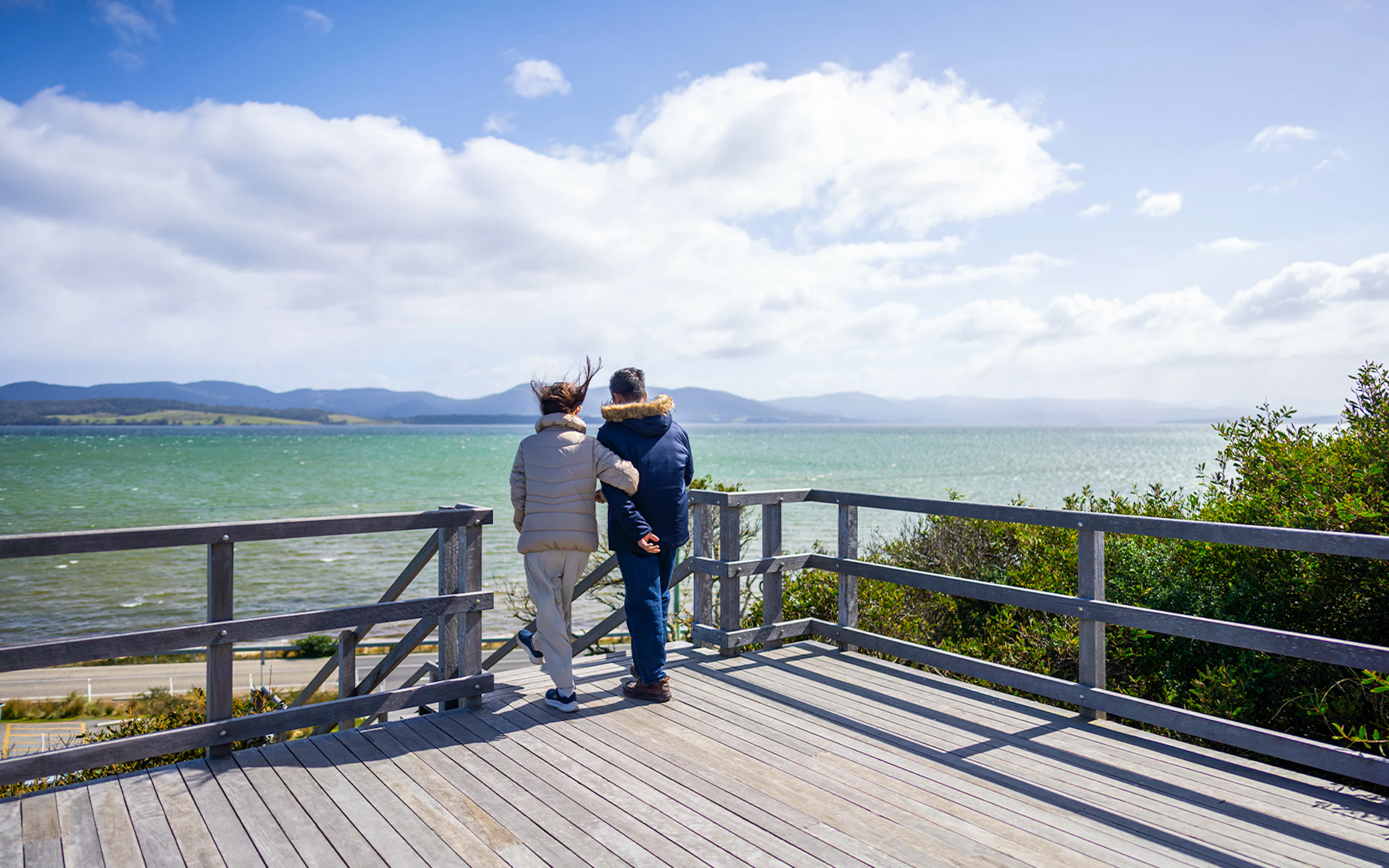 Couple enjoying Bruny Island coastline view, part of Hobart full-day guided tour.