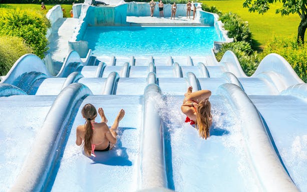 Visitors enjoying water slides at Parco Cavour Water Park, Italy.