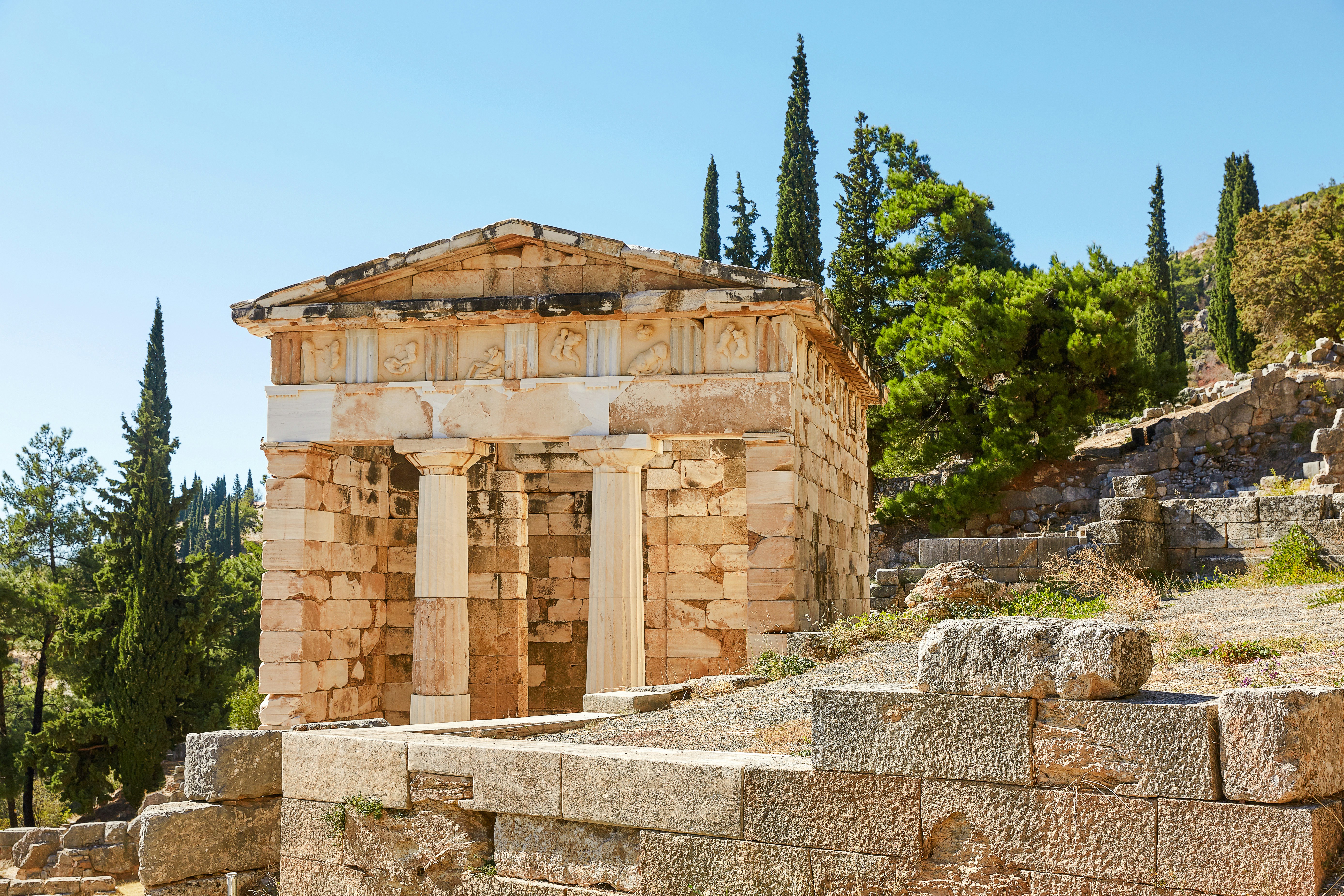 Athenian Treasury at Delphi with ancient stone structure and columns.