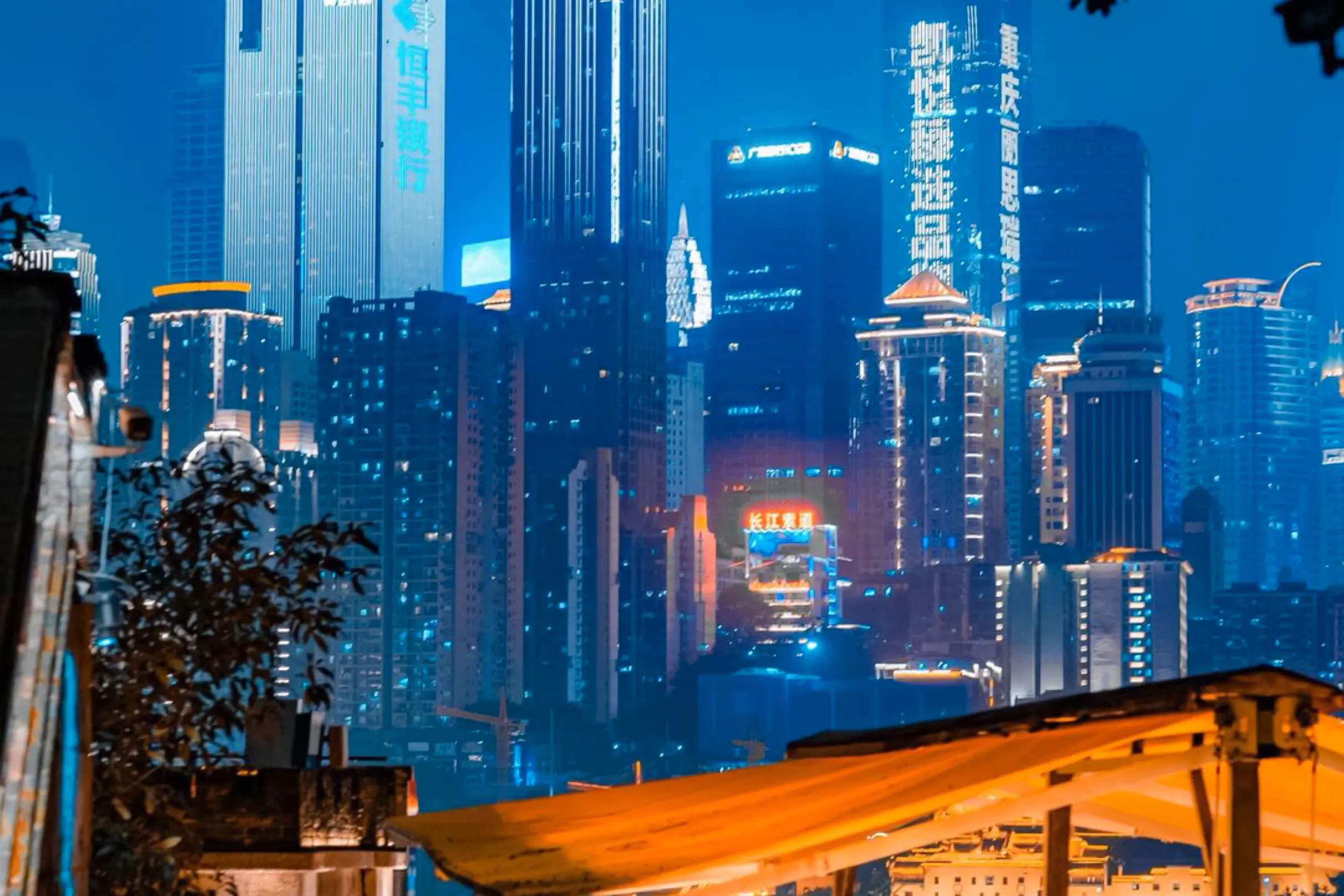 Chongqing skyline illuminated at night, viewed from a rooftop during the Chongqing Night Tour.
