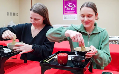 Tourists participating in a tea ceremony in Kyoto's Karasuma area.