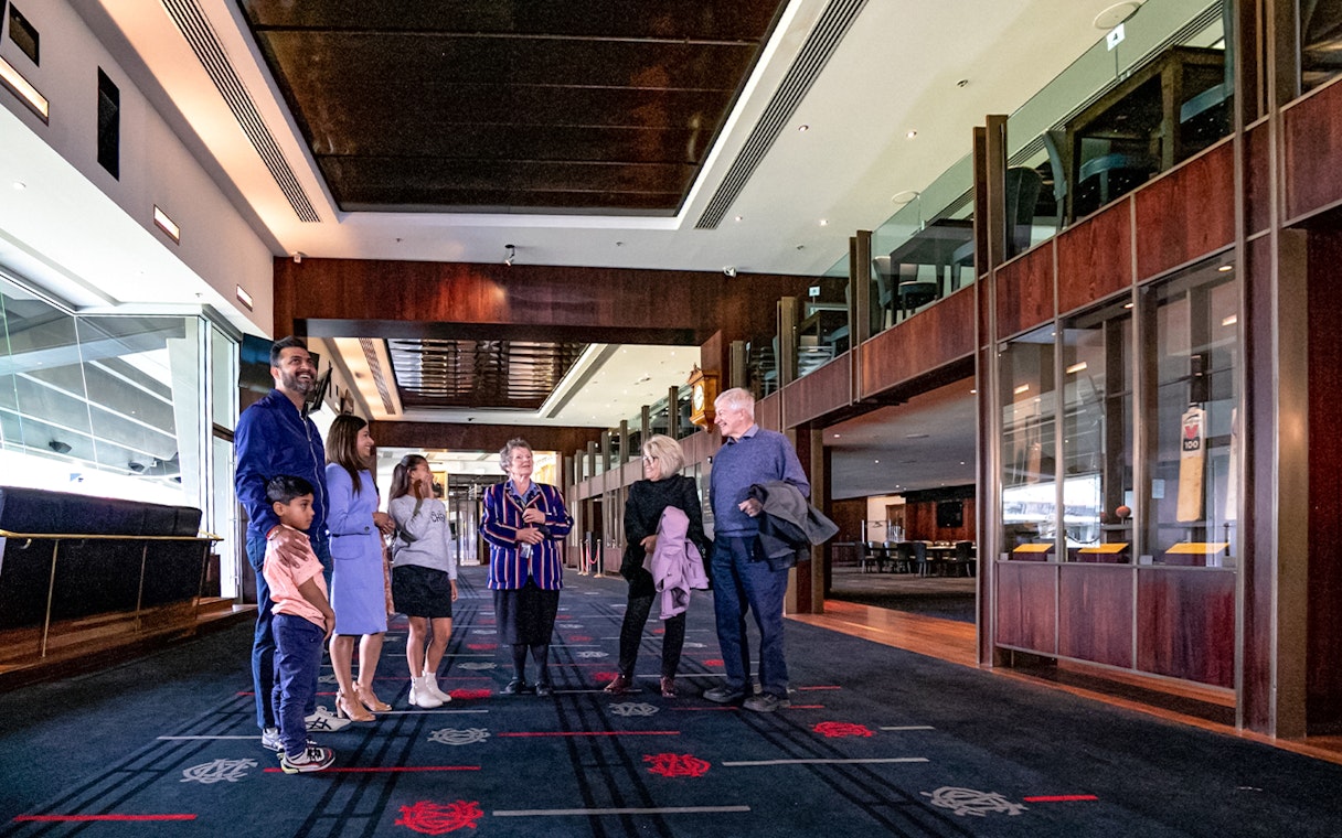 Group touring MCG Stadium interior on Melbourne sports walking experience.