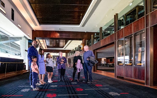 Group touring MCG Stadium interior on Melbourne sports walking experience.