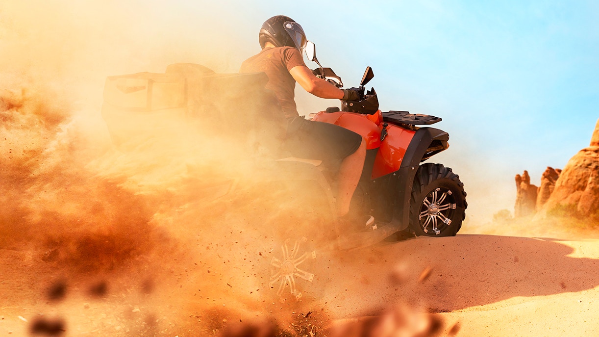 Quad biking through sandy terrain in the Dubai desert.