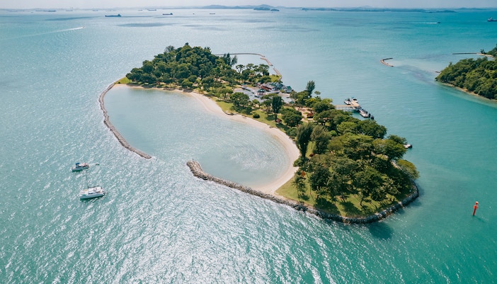 Aerial view of Lazarus Island with sandy beaches and lush greenery surrounded by turquoise waters.