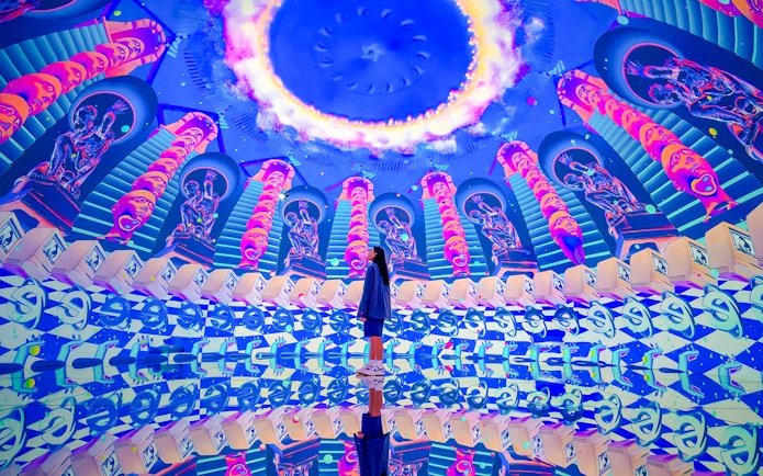 Tourist exploring vibrant digital art installation at House of Hype.