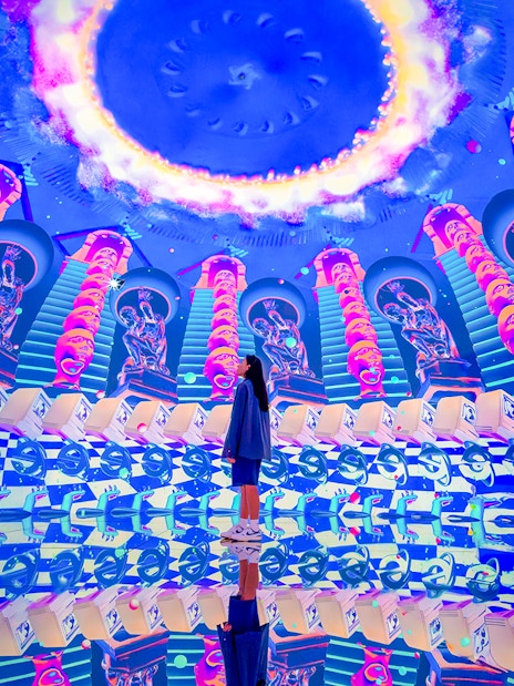 Tourist exploring vibrant digital art installation at House of Hype.