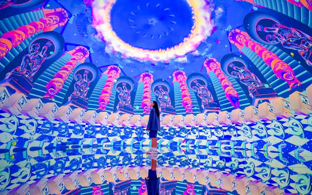 Tourist exploring vibrant digital art installation at House of Hype.