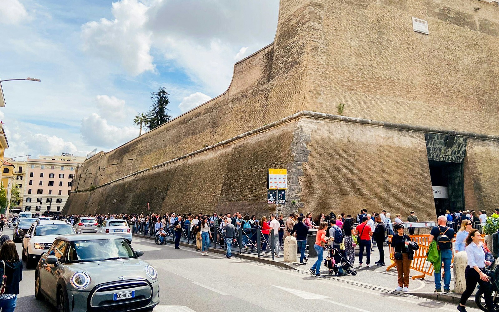 Visitors in line outside Vatican City walls, Rome, May 2023.