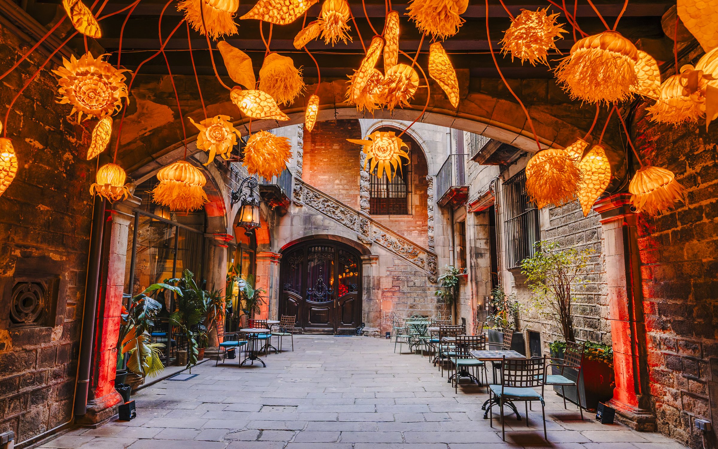Outdoor seating area at Palau Dalmases Flamenco Show with decorative lights.