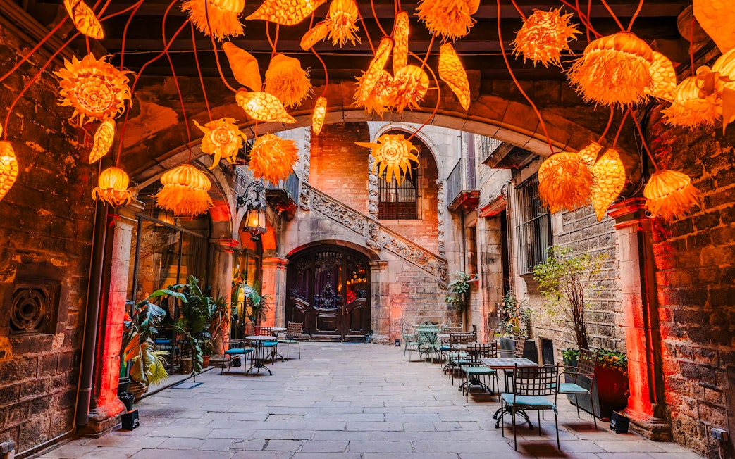 Outdoor seating area at Palau Dalmases Flamenco Show with decorative lights.
