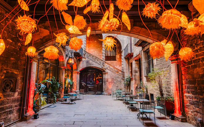 Outdoor seating area at Palau Dalmases Flamenco Show with decorative lights.